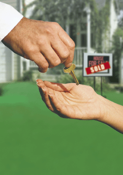 Photo of house with sold sign and someone handing a key to the new owner